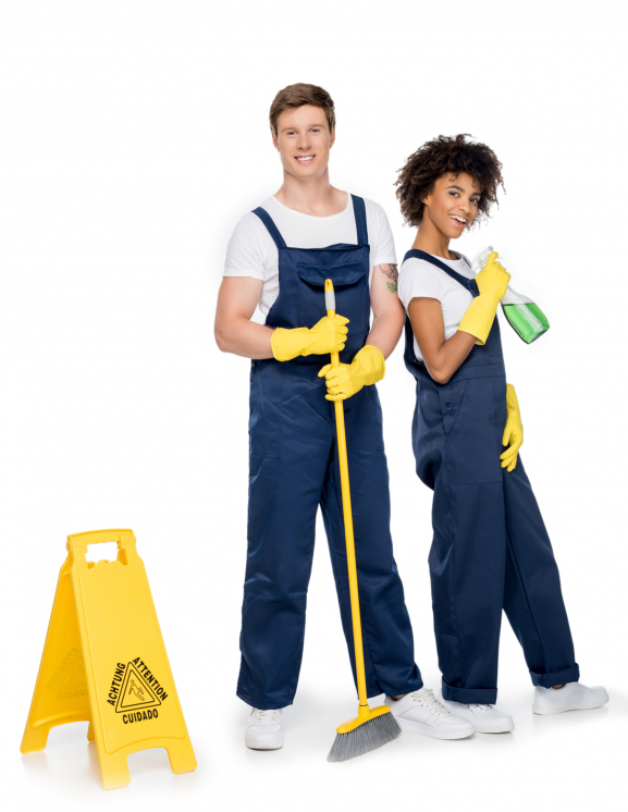 smiling multiethnic cleaners with cleaning supplies and warning sign looking at camera isolated on